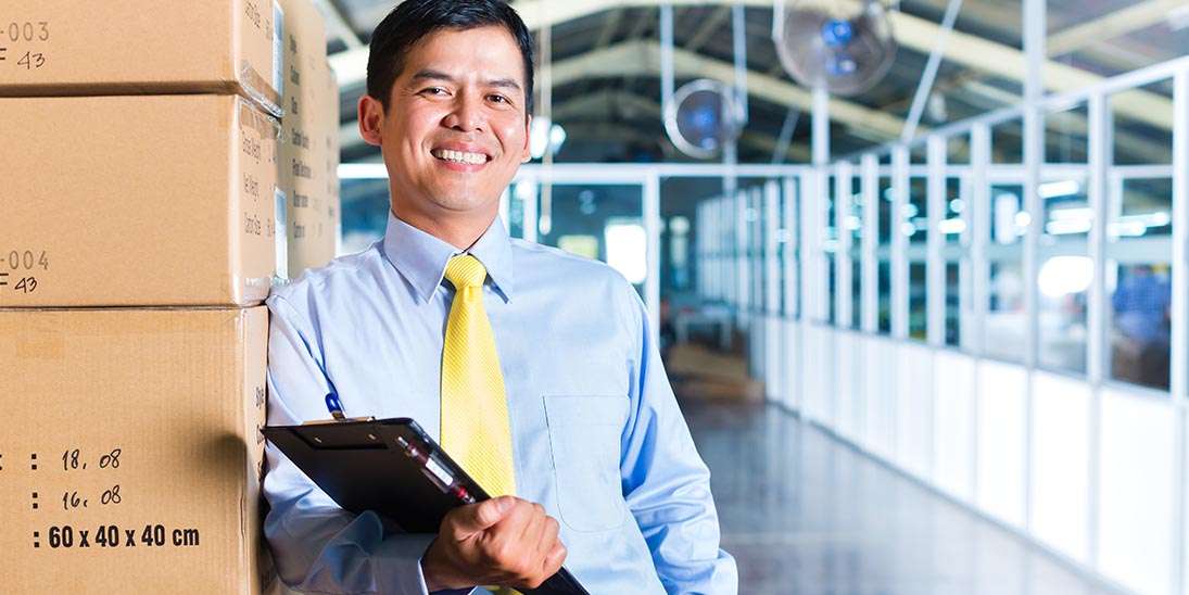 Manufacturing Orders with Business Man leaning on Box